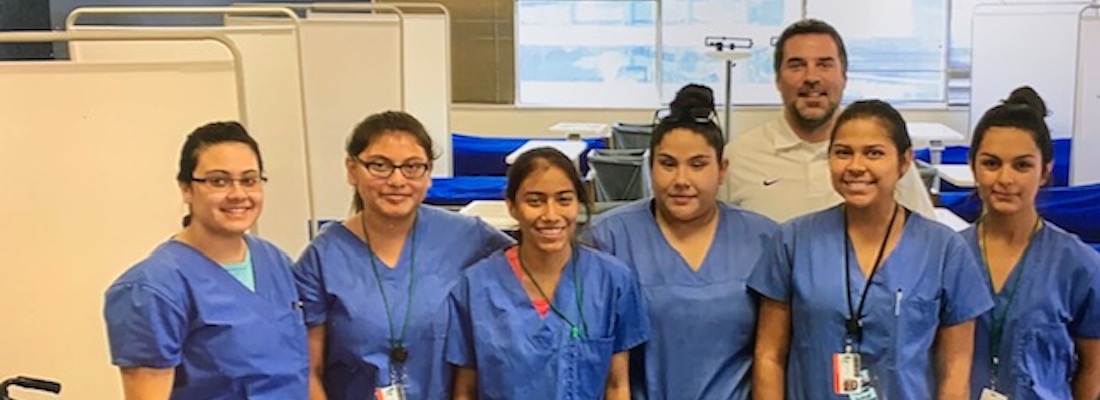 Group of students posing in scrubs